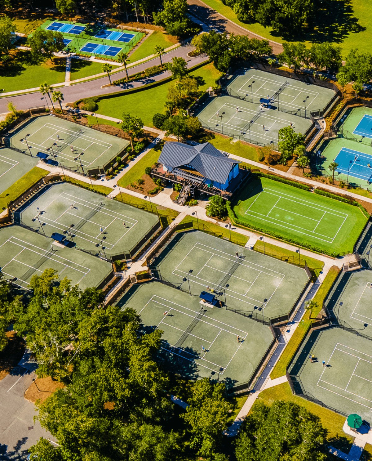 the racquet centre from the air, hard courts and a grass court