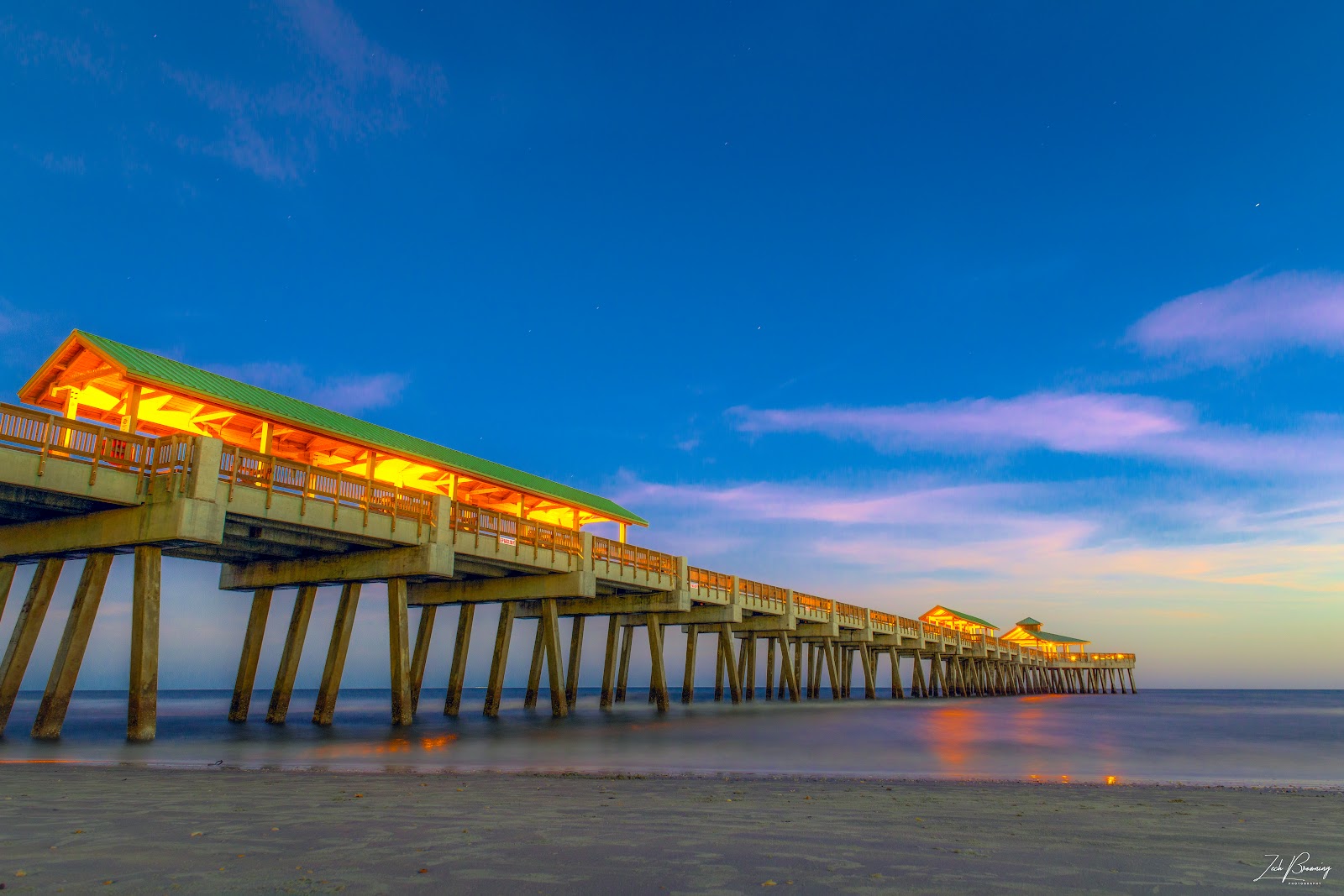 The pier at Folly Beach at dusk under a clearing sky