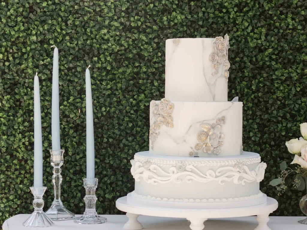 A three-tier marble-fondant wedding cake with sugar flowers, by Sugar Whisk Confections in Savannah